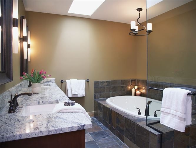 Primary bathroom with stone tub surround and double vanity