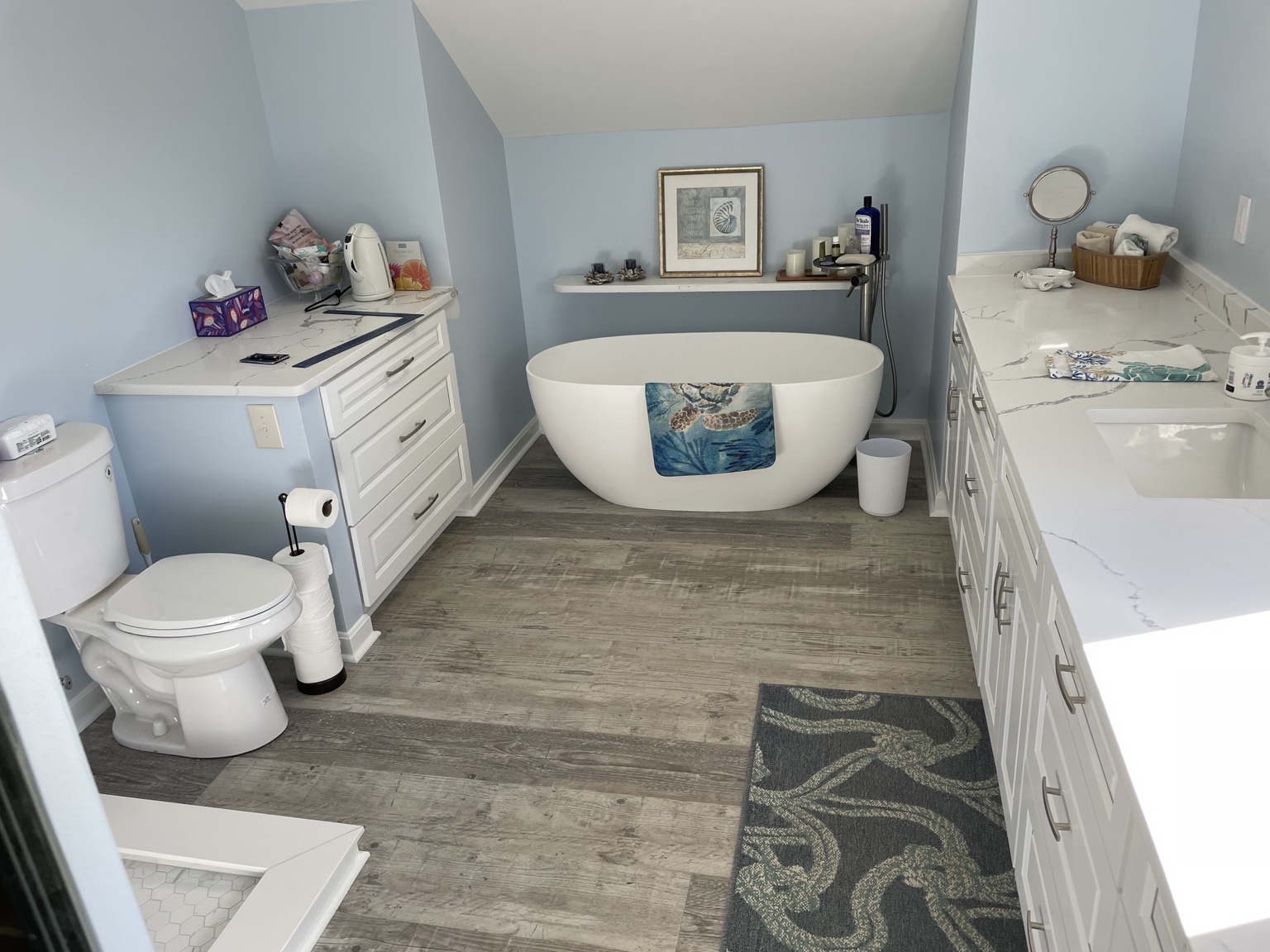 Completed primary bathroom with freestanding tub and double vanity