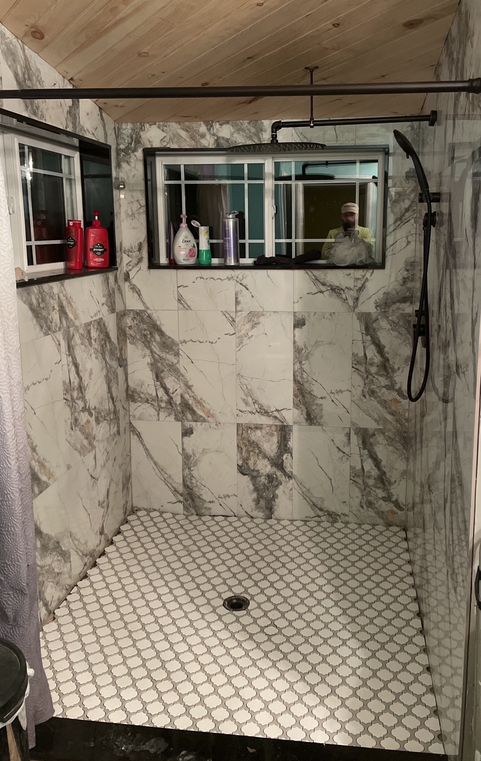 Completed walk-in shower with marble-look tile and glass enclosure